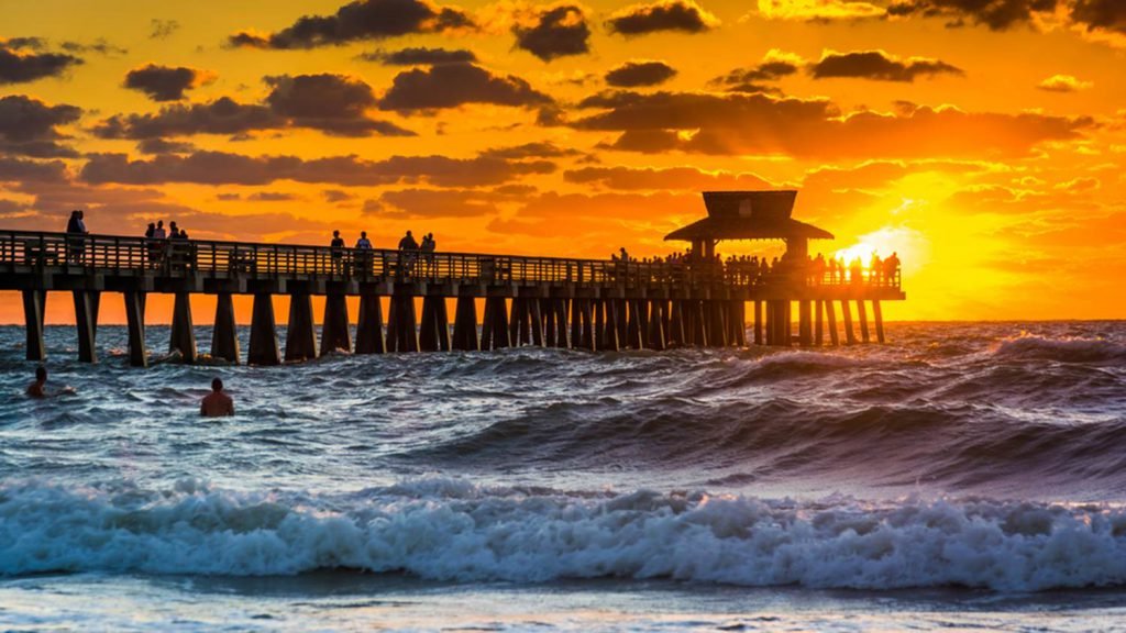 sunset on jetty waves crashing